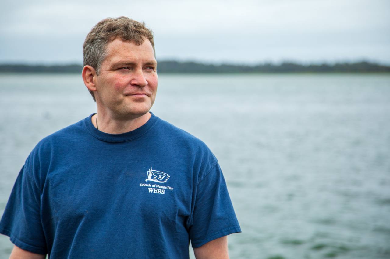 Alan Barton, manager of Whiskey Creek Shellfish Hatchery, overlooking the bay. Credit: Impact Media Lab / AAAS