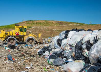 A tractor moves piles of trash at the Dane County Landfill.