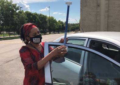 Dr. Hines, from Jackson State University, setting heat mapping equipment on a volunteer's car, August, 2020